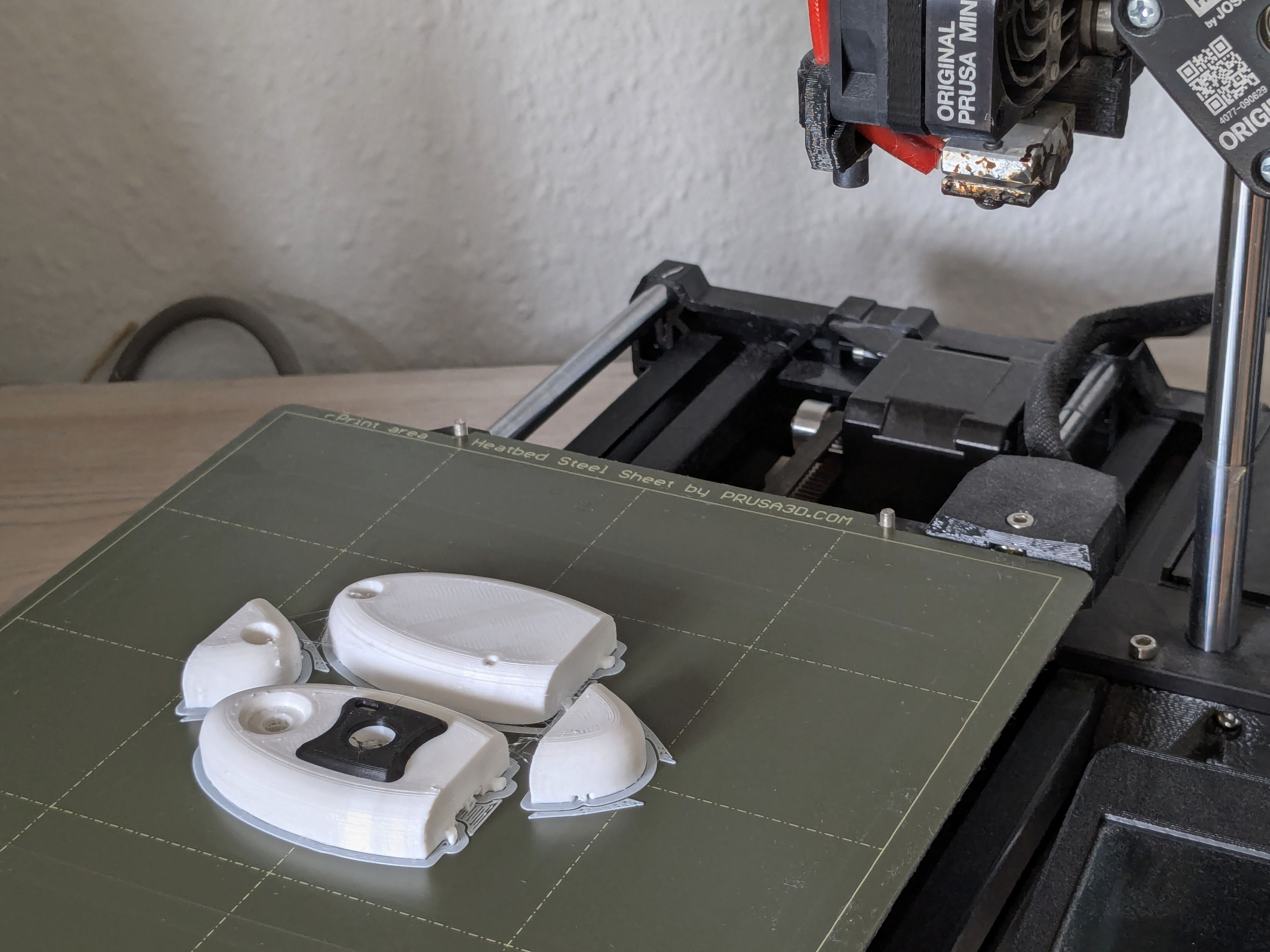 The PebbleCam shell parts on a Prusa Mini printer.