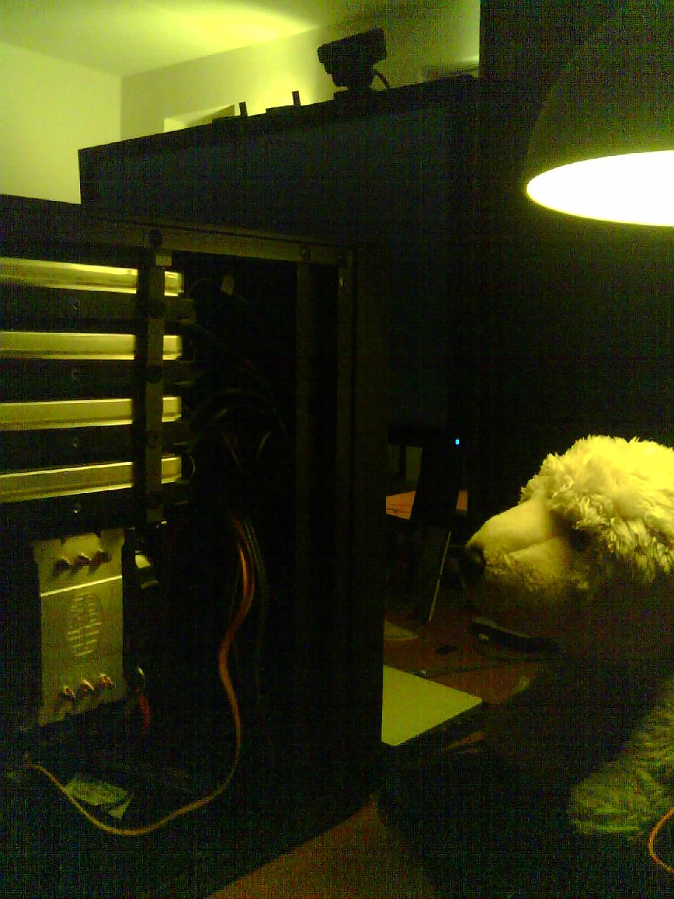 A teddy bear helping build a computer.