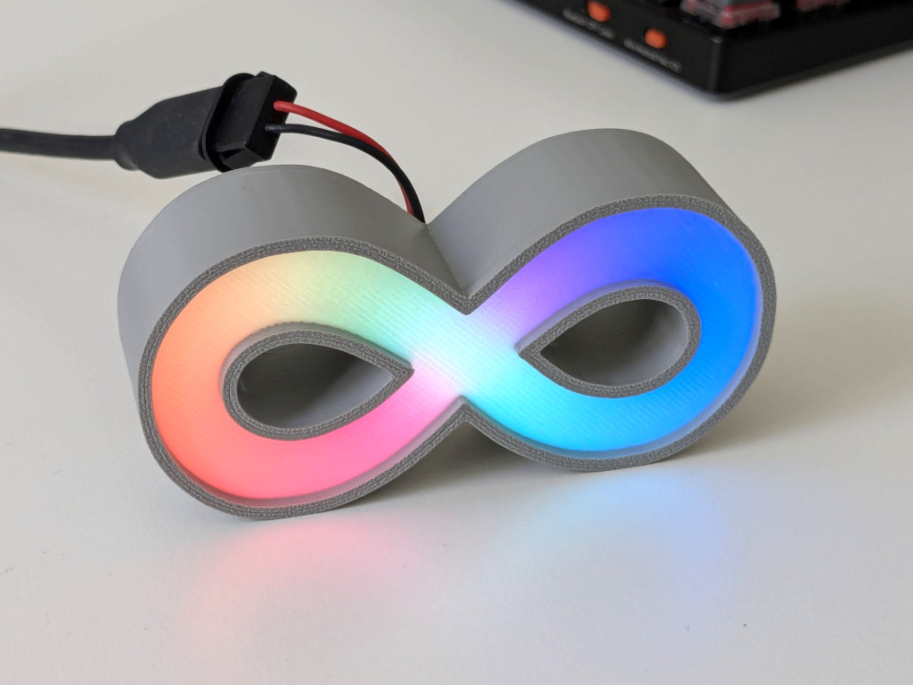 A badge in a grey PLA case
